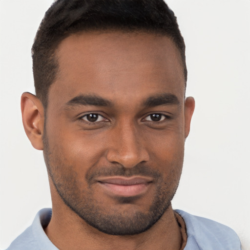 Joyful black young-adult male with short  brown hair and brown eyes