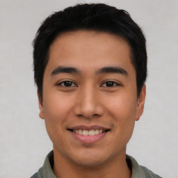 Joyful asian young-adult male with short  black hair and brown eyes