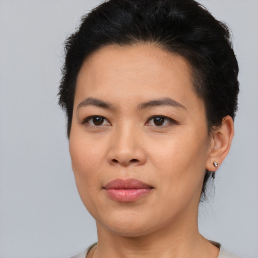 Joyful asian young-adult female with short  brown hair and brown eyes