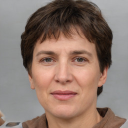 Joyful white adult female with short  brown hair and brown eyes