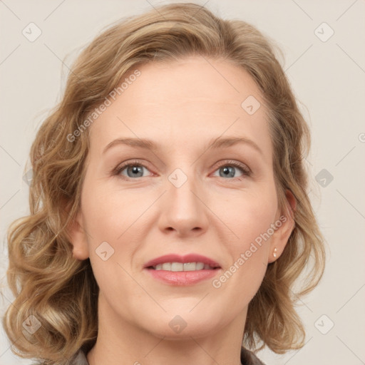 Joyful white adult female with medium  brown hair and blue eyes