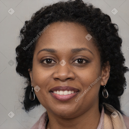 Joyful black young-adult female with long  brown hair and brown eyes