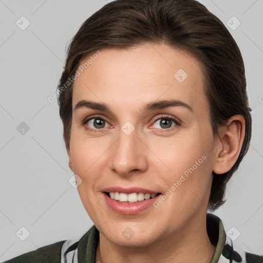 Joyful white young-adult female with medium  brown hair and grey eyes