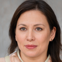 Joyful white adult female with long  brown hair and brown eyes