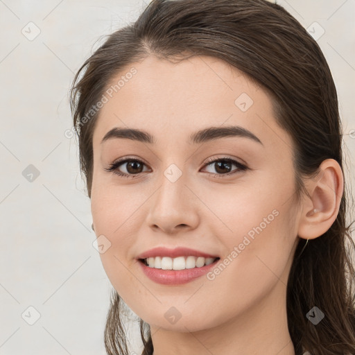 Joyful white young-adult female with long  brown hair and brown eyes