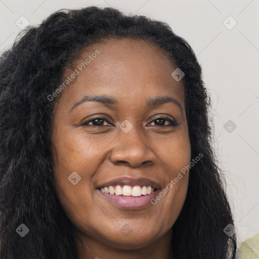 Joyful black young-adult female with long  brown hair and brown eyes