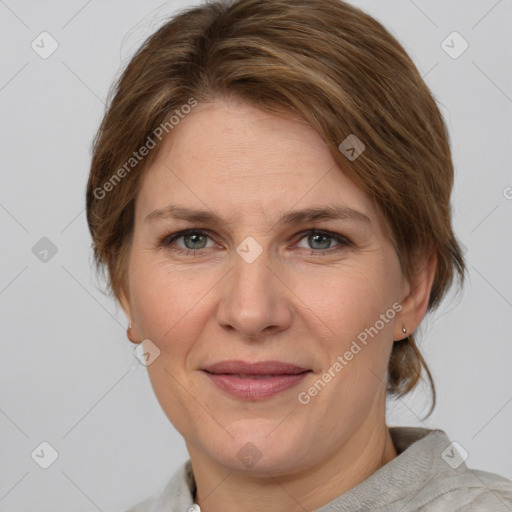 Joyful white adult female with medium  brown hair and grey eyes