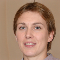 Joyful white young-adult female with medium  brown hair and blue eyes