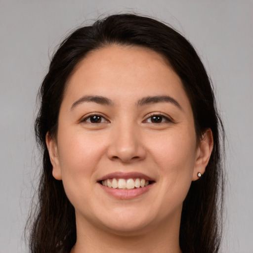 Joyful white young-adult female with long  brown hair and brown eyes