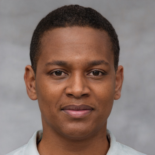 Joyful latino young-adult male with short  brown hair and brown eyes