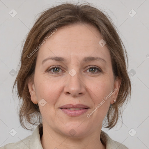 Joyful white adult female with medium  brown hair and grey eyes