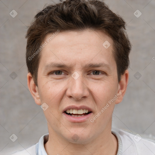 Joyful white young-adult male with short  brown hair and grey eyes