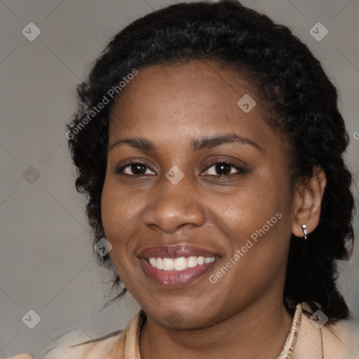 Joyful black young-adult female with long  black hair and brown eyes