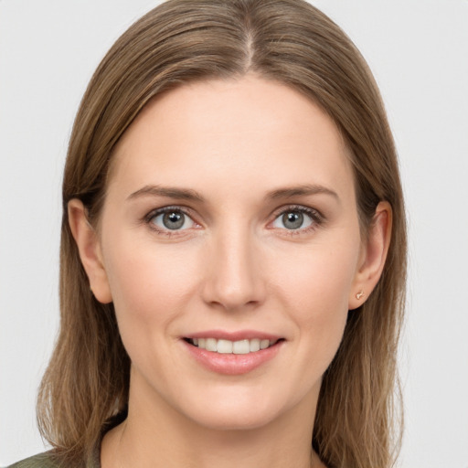 Joyful white young-adult female with long  brown hair and grey eyes