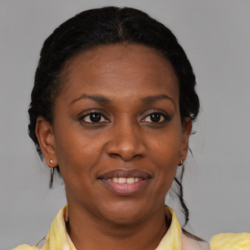 Joyful black young-adult female with medium  brown hair and brown eyes