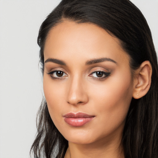 Joyful latino young-adult female with long  brown hair and brown eyes