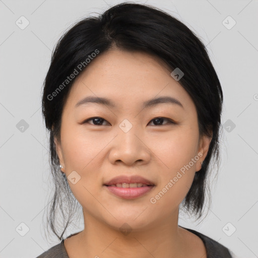 Joyful asian young-adult female with medium  black hair and brown eyes