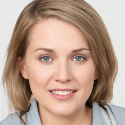 Joyful white young-adult female with medium  brown hair and blue eyes