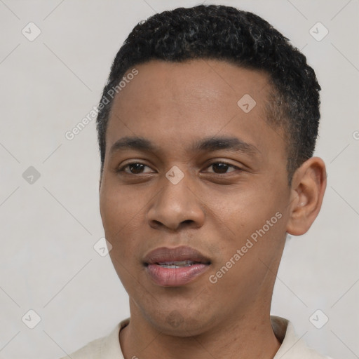 Joyful black young-adult male with short  black hair and brown eyes