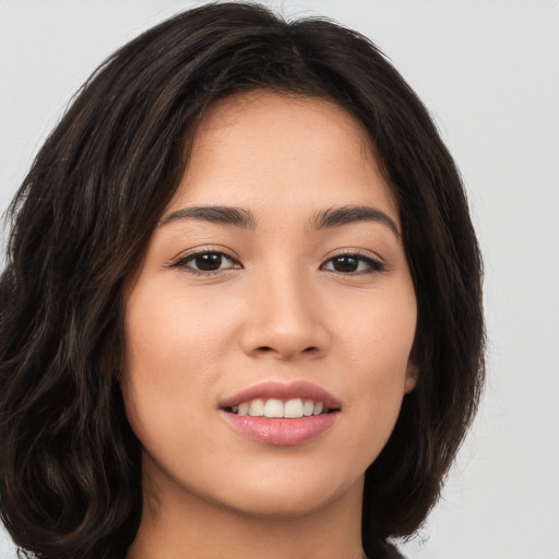 Joyful white young-adult female with long  brown hair and brown eyes