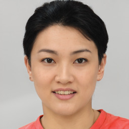 Joyful asian young-adult female with short  black hair and brown eyes