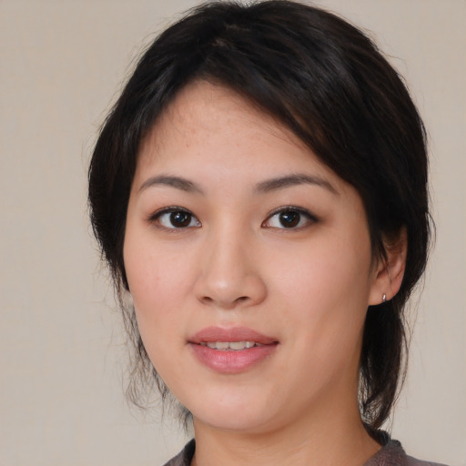 Joyful asian young-adult female with medium  brown hair and brown eyes