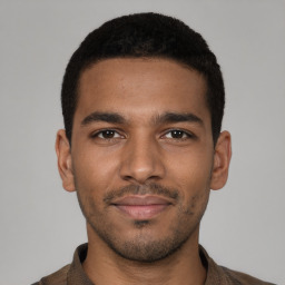 Joyful black young-adult male with short  brown hair and brown eyes