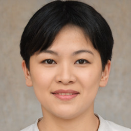 Joyful asian young-adult female with short  black hair and brown eyes