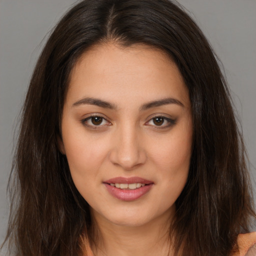 Joyful white young-adult female with long  brown hair and brown eyes