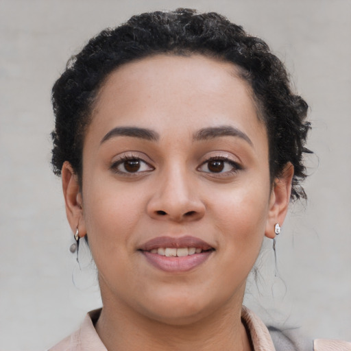 Joyful latino young-adult female with short  brown hair and brown eyes