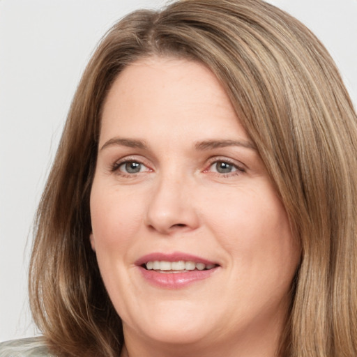 Joyful white adult female with long  brown hair and brown eyes