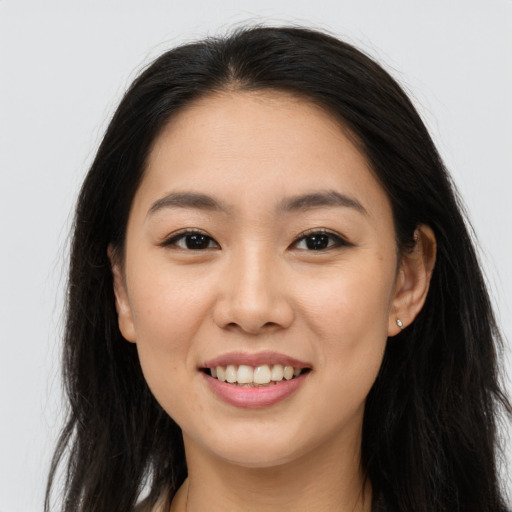 Joyful asian young-adult female with long  brown hair and brown eyes