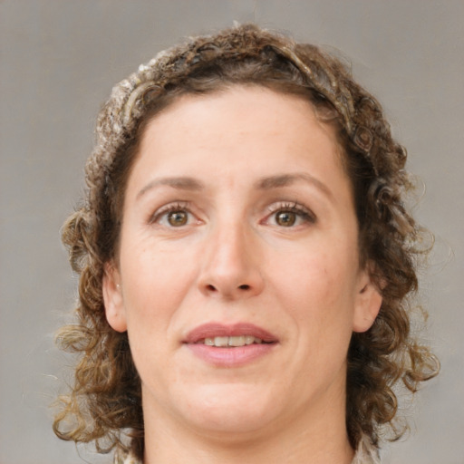 Joyful white adult female with medium  brown hair and green eyes