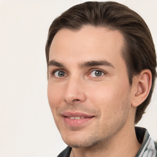 Joyful white young-adult male with short  brown hair and brown eyes