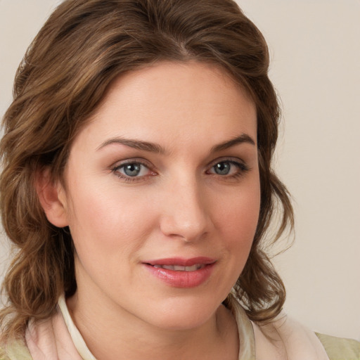 Joyful white young-adult female with medium  brown hair and blue eyes