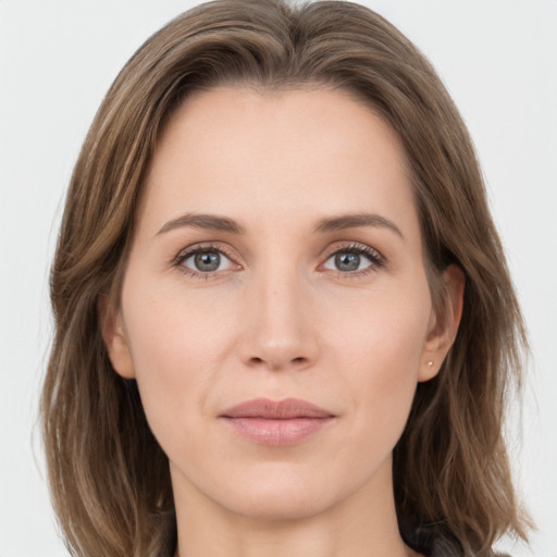 Joyful white young-adult female with medium  brown hair and grey eyes