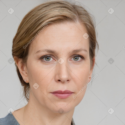 Joyful white adult female with medium  brown hair and blue eyes