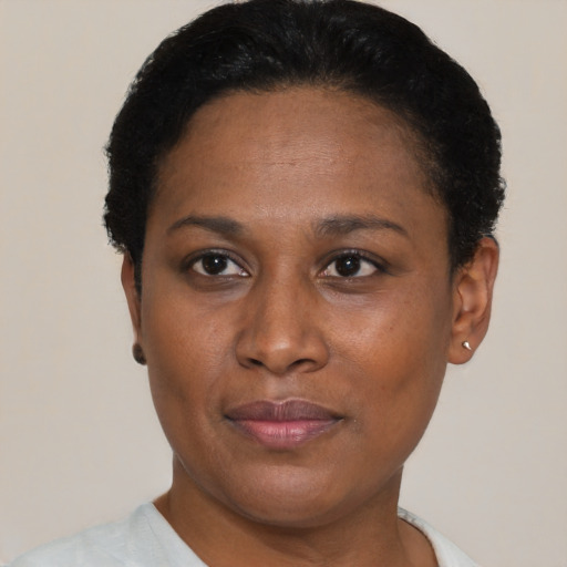 Joyful black adult female with short  black hair and brown eyes