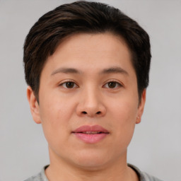 Joyful asian young-adult male with short  brown hair and brown eyes