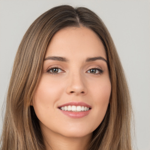 Joyful white young-adult female with long  brown hair and brown eyes