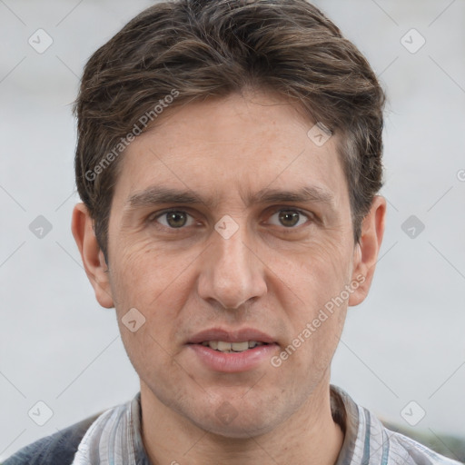 Joyful white adult male with short  brown hair and grey eyes