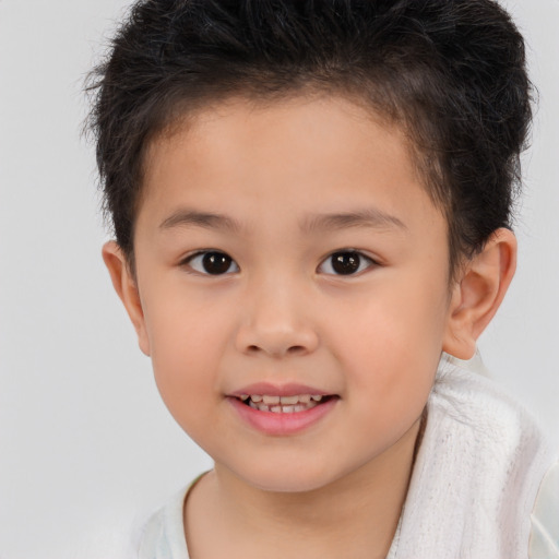 Joyful white child male with short  brown hair and brown eyes