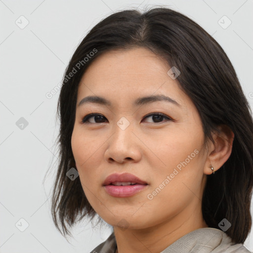 Joyful asian young-adult female with medium  brown hair and brown eyes