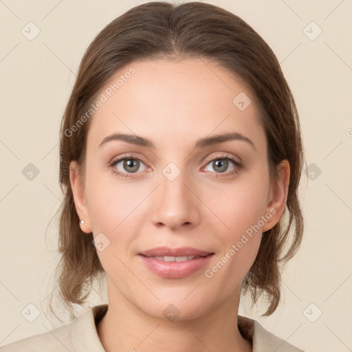 Joyful white young-adult female with medium  brown hair and grey eyes