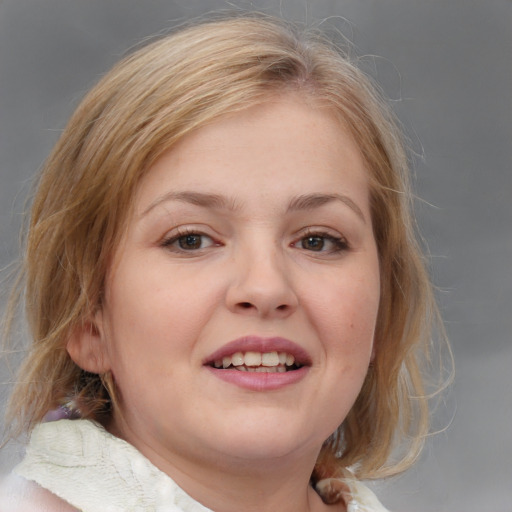 Joyful white young-adult female with medium  brown hair and blue eyes