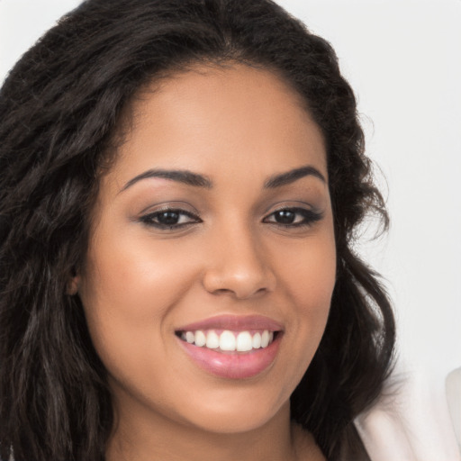 Joyful latino young-adult female with long  brown hair and brown eyes