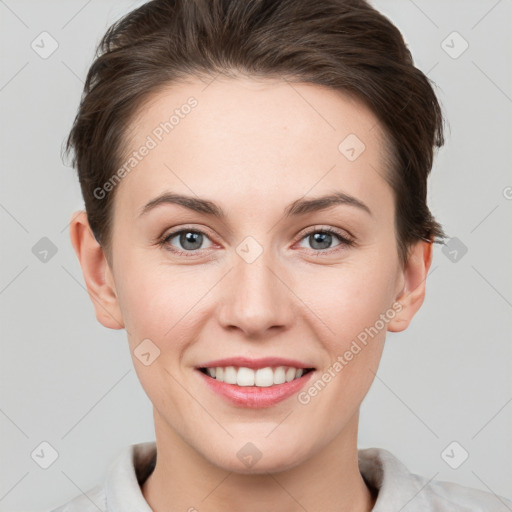 Joyful white young-adult female with short  brown hair and grey eyes