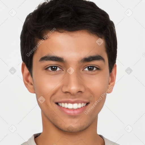 Joyful latino young-adult male with short  brown hair and brown eyes