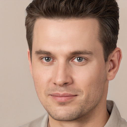 Joyful white young-adult male with short  brown hair and brown eyes