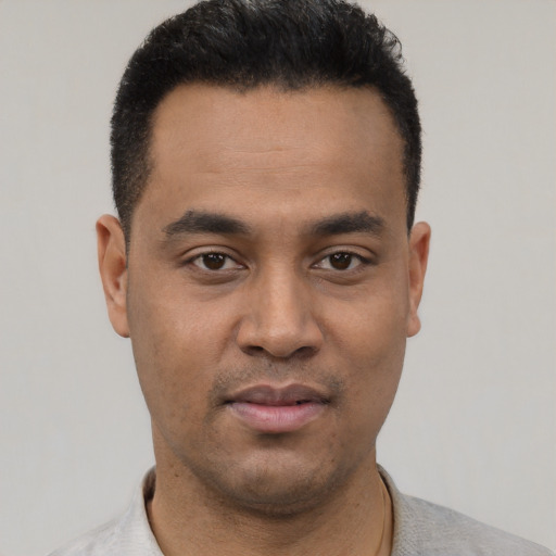 Neutral latino young-adult male with short  black hair and brown eyes